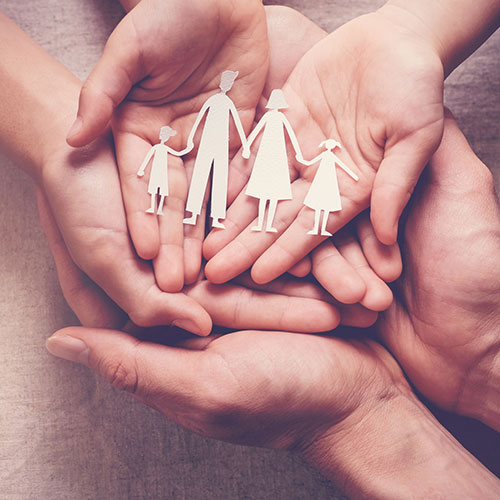 Hands holding a paper family