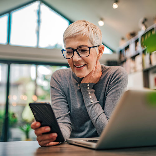 A woman reviewing information at her laptop